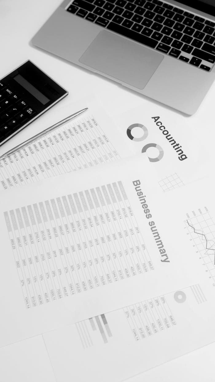 Crafting Captivating Headlines: Your awesome post title goes here Overhead view of a workspace with financial documents, laptop, and calculator, ideal for business analysis concepts.
